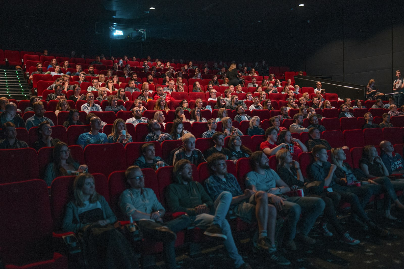Audience in red cinema seats during a film screening